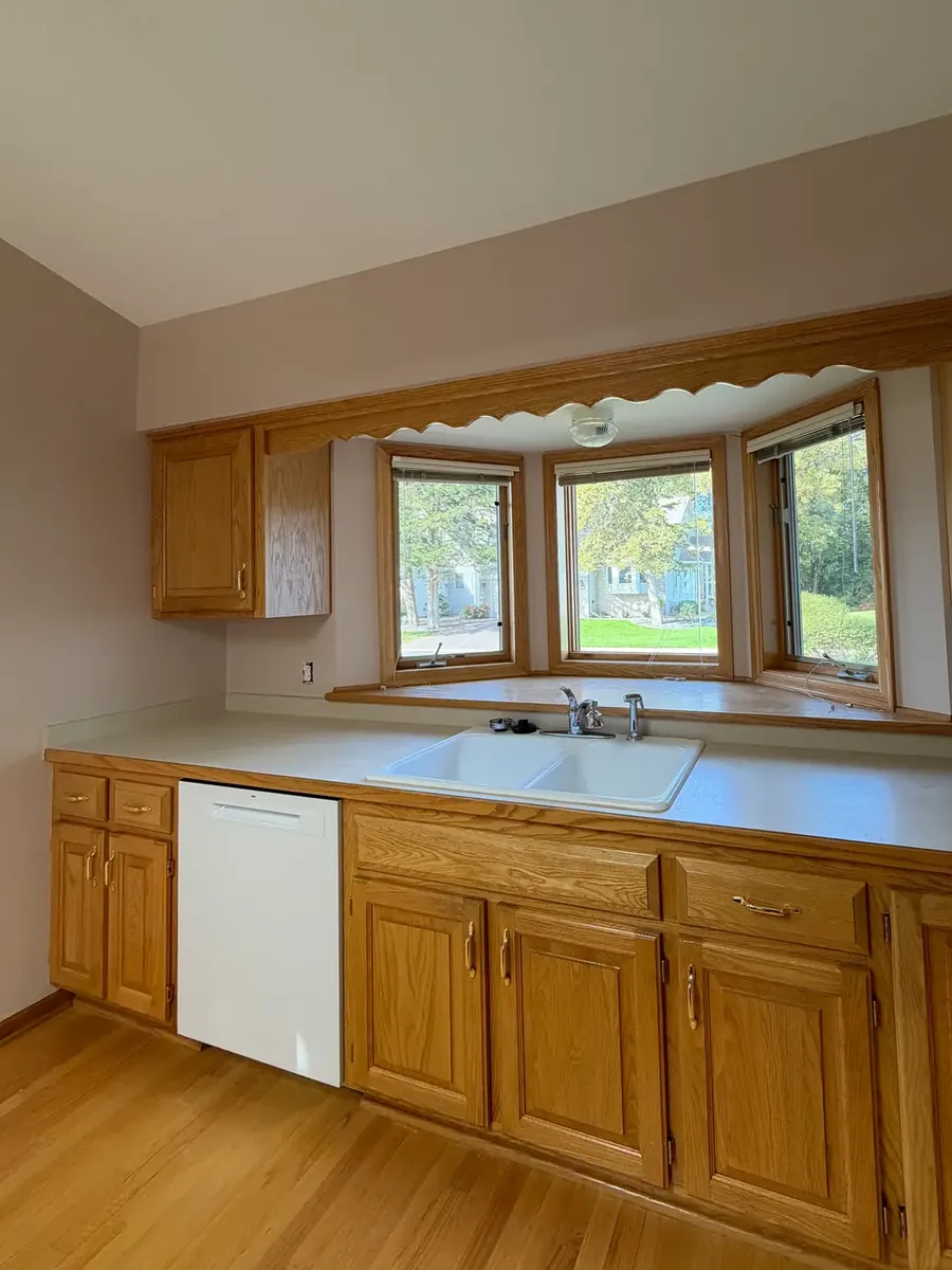 The same Anoka townhome kitchen after painting the walls, oak cabinets left as they were.