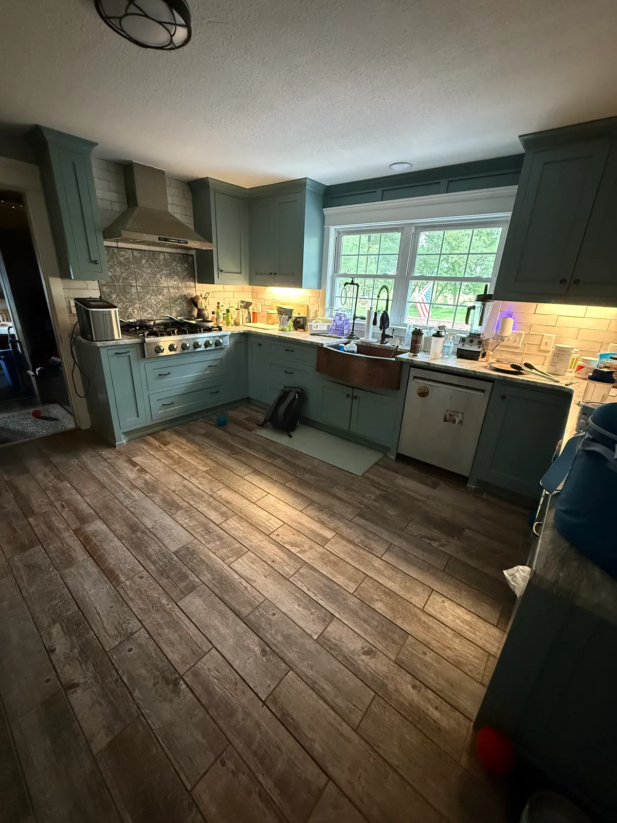 Elk River kitchen with sage green painted cabinets, after.